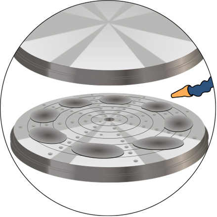 Illustration of a series of silicon computer disc wafers aligned on a rotary grinding table for lapping